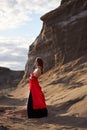 Beautiful anime woman in the sand. Red corset on the girl`s body. Bright red makeup on the face Royalty Free Stock Photo