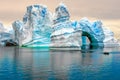 Iceberg in Antarctica, ice castle with Zodiac in front. Huge iceberg sculptured like fairytale castle Royalty Free Stock Photo