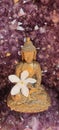 Beautiful brass Buddha statue in an amethyst crystal geode