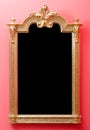 Beautiful antique wooden mirror frame in golden colors mounted o