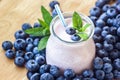Beautiful appetizer blueberry fruit smoothie milk shake glass jar with juicy fresh berries background top view Yogurt cocktail Nat
