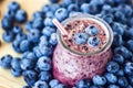 Beautiful appetizer blueberry fruit smoothie milk shake glass jar with juicy fresh berries background top view Yogurt cocktail Nat