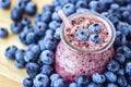 Beautiful appetizer blueberry fruit smoothie milk shake glass jar with juicy fresh berries background top view Yogurt cocktail Nat