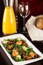 Beautiful appetizer crayfish salad, decorated vegetables cucumber and rukola. Wooden background. Close up. Fried shrimps. Royalty Free Stock Photo