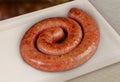 Pork sausage, traditional brazilian barbecue whole piece on a tray. Royalty Free Stock Photo