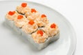 Beautiful appetizing rolls of sushi on a white plate