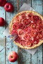 Beautiful apple rose pie with cream filling served with red apples. Homemade healthy dessert Royalty Free Stock Photo