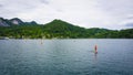 Beautiful Aps landscape with big lake surrounded by green mountains, sailing people