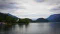 Beautiful Aps landscape with lake, green mountains, valley, forest and church on the Coast