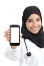 Beautiful arab female doctor showing a blank smart phone screen isolated