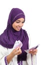 Beautiful arab woman counting a lot of five hundred euros banknotes