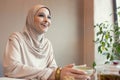 Beautiful arab woman meeting at cafe or restaurant with friend, spending time with cup of tea Royalty Free Stock Photo