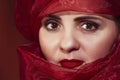 Beautiful arab woman in a red headdress. Portrait of an Arab woman. Portrait close-up