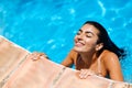 Beautiful Arab woman relaxing in swimming pool.