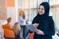 Beautiful Arabian girl with tablet computer working at startup office