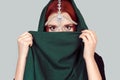 Beautiful Arabian style girl portrait. Portrait of beauty Indian model with bright make-up who is hiding, cover her face behind