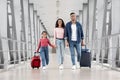 Beautiful Arabic Family Of Three With Suitcases Walking At Airport Terminal Together Royalty Free Stock Photo