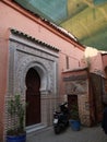 Beautiful arabic gate with a motorbike and plants in Marrakech Royalty Free Stock Photo