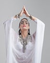 Beautiful arabic woman praying on gray Royalty Free Stock Photo