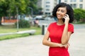 Beautiful arabic young adult woman talking with boyfriend at mobile phone Royalty Free Stock Photo