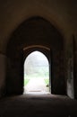 Beautiful arch open doorway leading to a sunny country park.