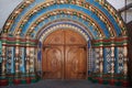 Arched wooden door in a stone wall