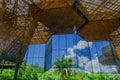 Beautiful architectural woodden structure, with some vegetation behind, in a botanical greenhouse in Medellin