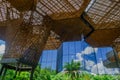 Beautiful architectural woodden structure, with some vegetation behind, in a botanical greenhouse in Medellin Royalty Free Stock Photo