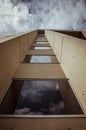 Beautiful architecture details of a modern building of concret an fiberglass, with a view on a blue cloudy sky Royalty Free Stock Photo