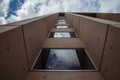 Beautiful architecture details of a modern building of concret an fiberglass, with a view on a blue cloudy sky Royalty Free Stock Photo