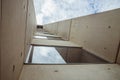 Beautiful architecture details of a modern building of concret an fiberglass, with a view on a blue cloudy sky Royalty Free Stock Photo