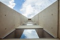 Beautiful architecture details of a modern building of concret an fiberglass, with a view on a blue cloudy sky Royalty Free Stock Photo