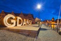 Beautiful architecture of Gdansk with an outdoor sign at dusk, Poland