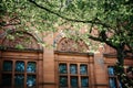 Beautiful architecture of Kelvingrove Museum in the shade of old tree foliage in Glasgow Scotland