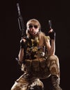 Beautiful army girl with gun isolated on the black background Royalty Free Stock Photo