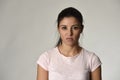 Beautiful arrogant and moody spanish woman showing negative feeling and contempt facial expression