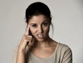 Beautiful arrogant and moody spanish woman showing negative feeling and contempt facial expression Royalty Free Stock Photo