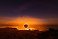 The beautiful art fire dancer swing fire dancing show on the beach with dark clouds , dark sky background. Royalty Free Stock Photo