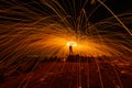 The beautiful art fire dancer swing fire dancing show on the beach with dark clouds , dark sky background. Royalty Free Stock Photo