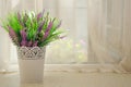 Beautiful artificial bouquet with lavender on the window