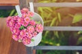 Beautiful artificial flowers in small pots hanging to decorate a railing walk for beauty on the pathway in public gardens.