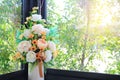 Beautiful artificial flowers in white ceramic vase decoration in living room near a window glass Royalty Free Stock Photo