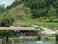 Beautiful view of the lake, with lots of vegetation around, buildings and blue sky with clouds.