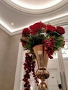 red artificial rose in the gold vase