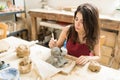 Beautiful Artisan Making Pottery Of Doll In Studio