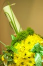 Closeup of a baptism candle with yellow flowers