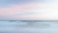 Beautiful artistic colorful landscape image of blurred waves at sunset in Devon Enlgand Royalty Free Stock Photo