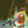 Beautiful artistic young couple cheerfully dancing near giant glass with alcohol cocktail. Contemporary art collage.