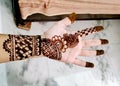 Beautiful artwork drawn on the hand of an Indian bride with herbal heena in wet condition Royalty Free Stock Photo