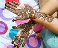 Beautiful artwork drawn on the hand of an Indian bride with herbal heena in wet condition Royalty Free Stock Photo